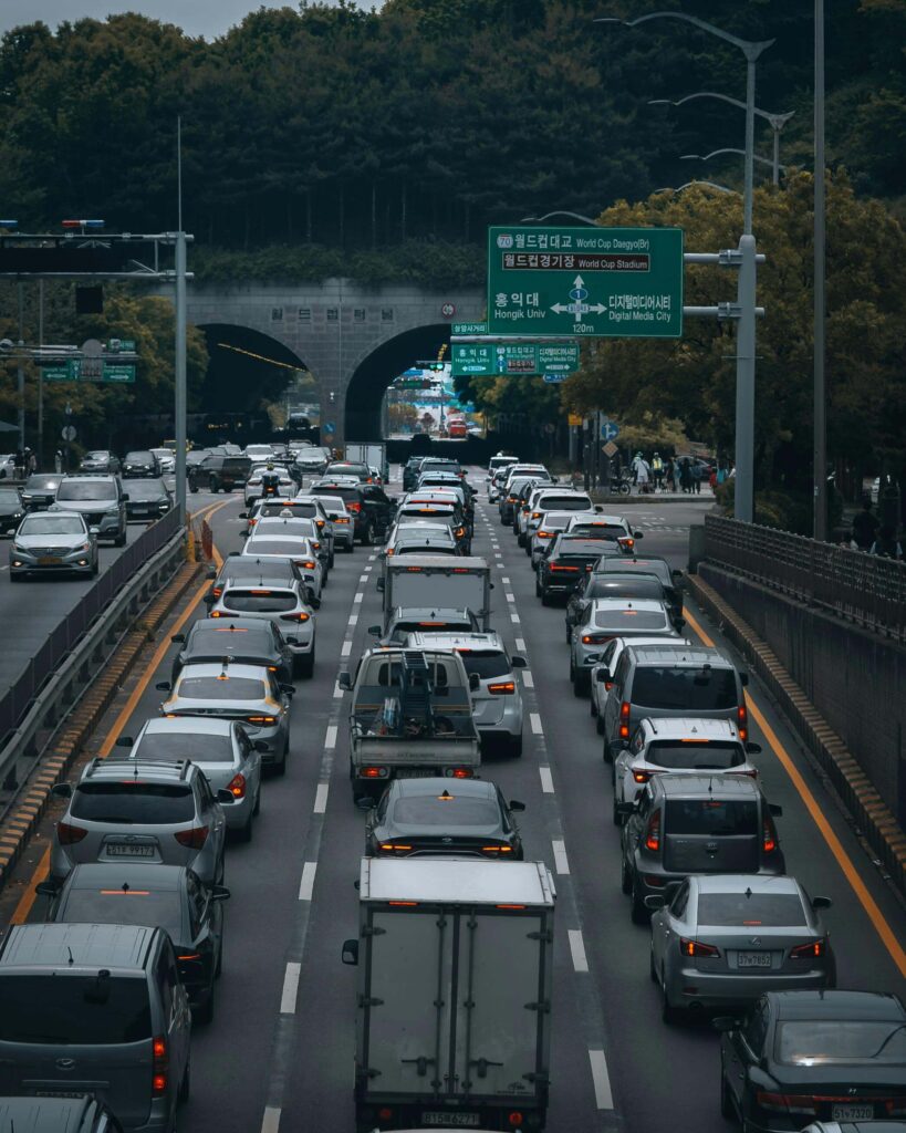 A busy highway filled with various cars and trucks, illustrating the traffic flow in Seoul capital during peak hour.