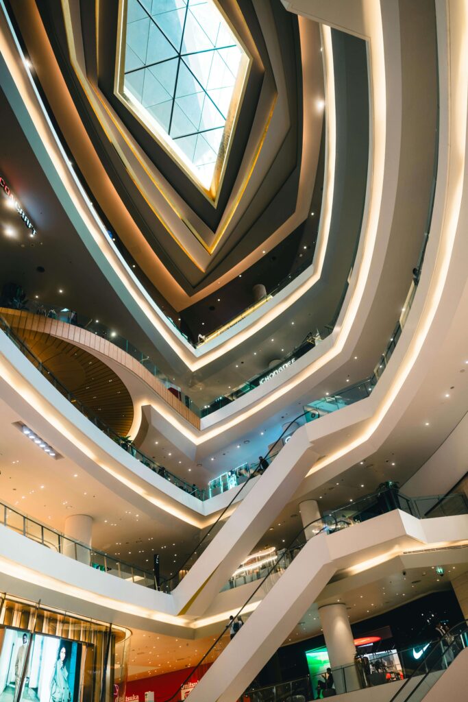 Modern shopping mall interior with bright lighting and trendy shops, highlighted in the "Top Places to Go" Bangkok itinerary.